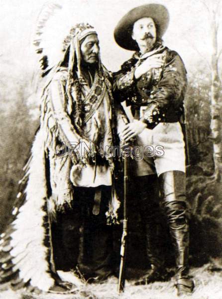 Sitting Bull stands next to Buffalo Bill Cody