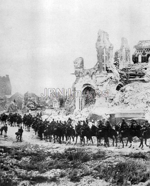 British cavalry ride past ruins 1916