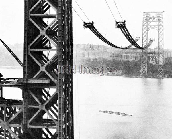 Workmen hoisting main-span cross bridges