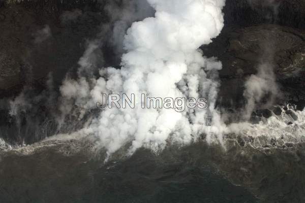 Lava from Pu'u 'O'o Vent flowing into the ocean;...