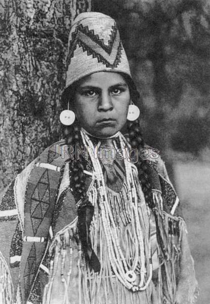 Umatilla woman wearing basketry hat