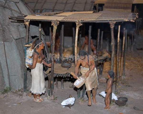 Indian women grinding acorns