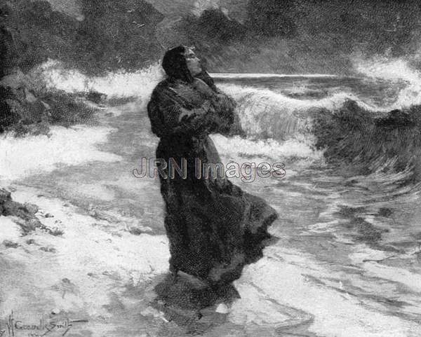 Cloaked woman walking the beach